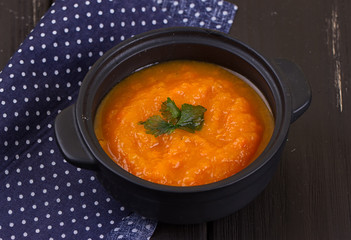pumpkin soup in a small black pot