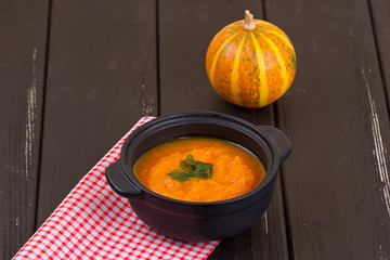 Pumpkin soup on a wooden table