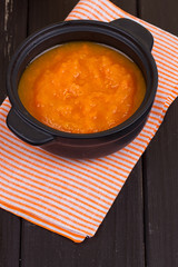 pumpkin soup in a small black pot