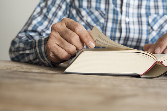 Man reading book on table