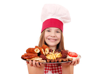 happy little girl cook with grilled meat on plate