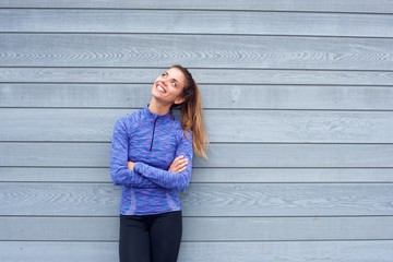 Happy woman in workout clothes looking up