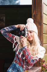 Young attractive woman in the cafe with camera