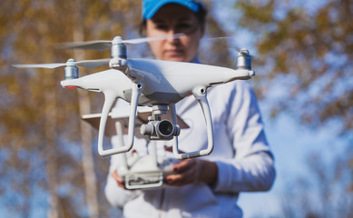 Flying the copter. Remote control in a women's hands