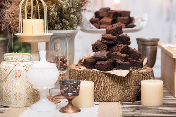 chocolate brownies in stacked on wooden table.