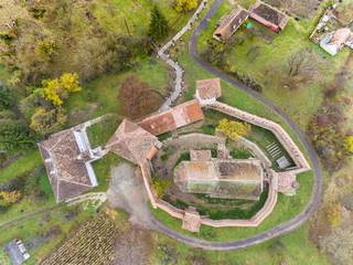 Saxon fortified church at Alma Vii Transylvania Romania. Aerial view from above.