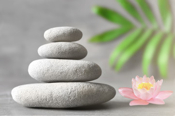Spa stones with flower lily on light background