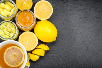 Cup of tea, overhead on black board. Hot tea with natural ingredients for cold and flu, text space