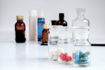 glass jars of pills - home first aid kit