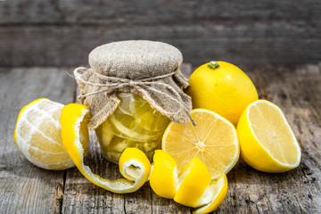 Slices of lemon in jar preserved in sugar. Homemade preserving food for winter. - obrazy, fototapety, plakaty
