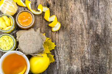 Lemon tea cup, top view on rustic wooden background. Hot tea with warming ginger and honey for a cold winter evening.