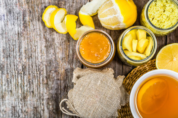 Cup of tea, overhead on wooden table. Hot tea with lemon, ginger an honey.
