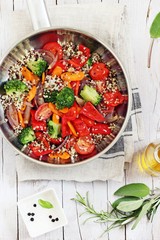 Warm quinoa and roasted vegetables salad on a rustic wooden table. Superfood concept.Selective focus 