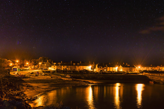 Craster Village at Night,under a starry sky on Northumberland Coast, with a hint of the Northern Lights
