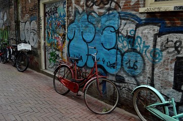Graffiti and bike in a street in Amsterdam

