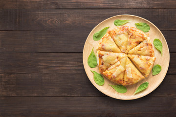 Pizza on wooden background. Copy space for your text.