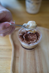 Scooping a banana banoffee from the cup