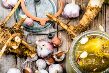 Homemade pickle with garlic and dill. Pickled gherkins in jar. Preserves.