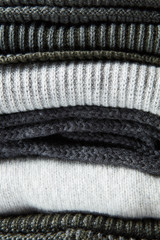 Stack of gray woolen knitted sweaters