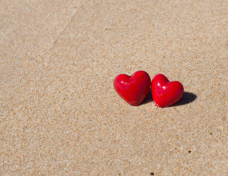 Red hearts on the beach. Couple in Love Valentines Day concept.