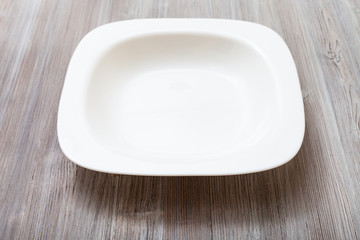 white bowl on gray brown board
