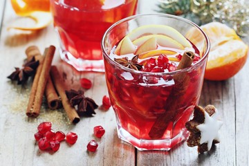 Mulled wine,punch,bowl oder spiced tea : winter traditional warming drinks with spicy,citrus fruits and pomegranate . Rustic style.Selective focus
