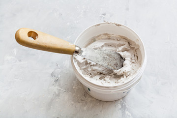 metal spatula in pot with putty