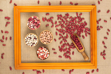 Beans of different colors in the portrait frame. Top view.