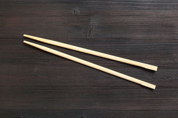 wooden disposable chopsticks on dark brown table