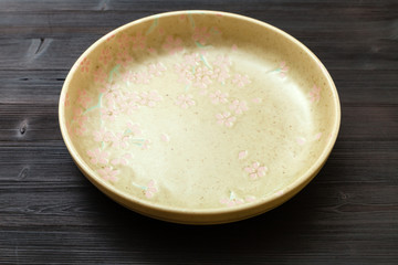 green plate on dark brown table