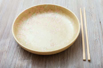 yellow green plate and chopsticks on gray