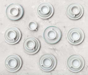 top view of many cups on saucers on concrete board