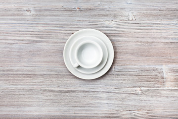 above view of cup with saucers on gray brown table