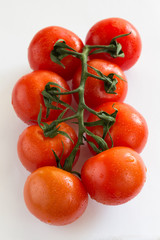  red tomatoes with green leaves. Top view.