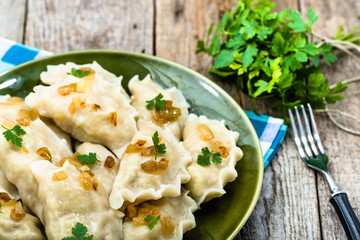 Russian dumplings with fried onion on plate, homemade cooking concept