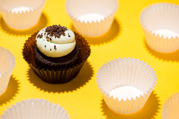 Birthday cupcake against a yellow background