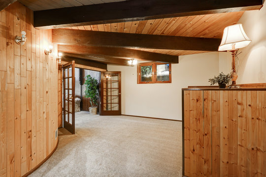 Wooden house interior with round wall and carpet floor