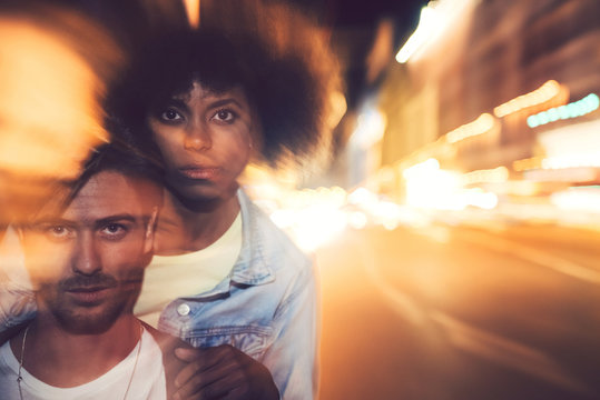 Beautiful interracial couple posing in a zoom in effect photo