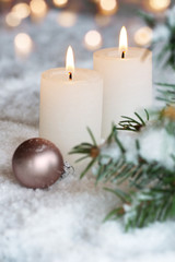 Fototapeta na wymiar Two Christmas candles in the snow