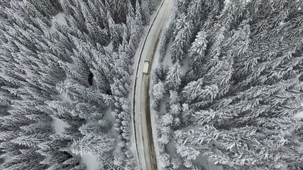 Curving Winding Snowy Winter Road with a Car Minibus