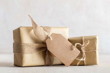 Rustic retro gifts, present boxes with tag. Christmas time, eco paper wrap.