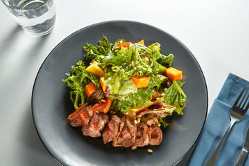 grilled meat duck with roasted pumpkin and fresh green salad