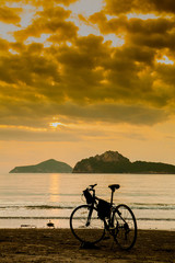 Fototapeta premium silhouette of a bike standing by the sea