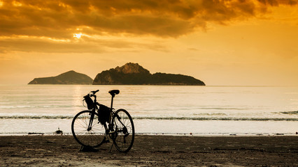 Fototapeta premium silhouette of a bike standing by the sea