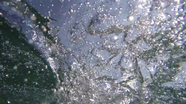 Man drowning in the sea, hand asking for help sticking out of cold water with air bubbles, pov shot