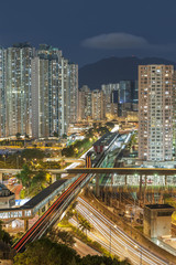 Fototapeta na wymiar Residential buildings and highway in Hong Kong at night