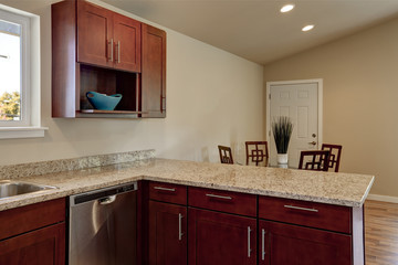 View of burgundy kitchen cabinets with granite counter top