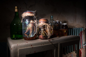 Horrible dead creatures with bulging eyes inside a pair of mason