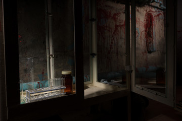 Stained laboratory with test tubes holder inside with blood spat