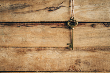 old key vintage hanging on wooden background with space